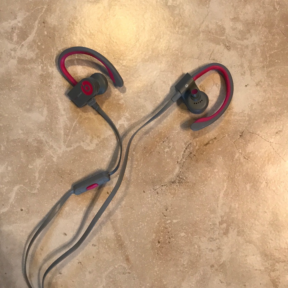 Power Beats wireless earbuds in grey and pink